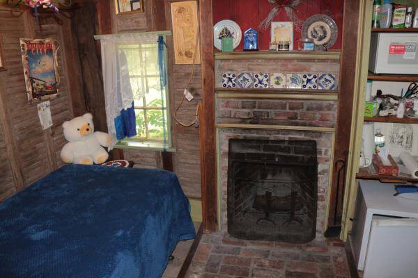 A bedroom with a bed and fireplace in it