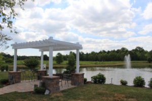 A gazebo sits in the middle of a park.