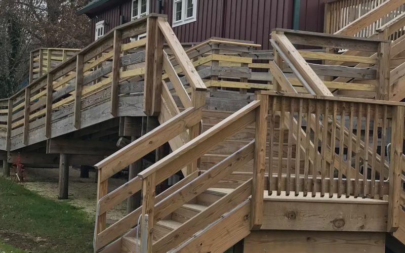 A wooden deck with stairs leading to the top.