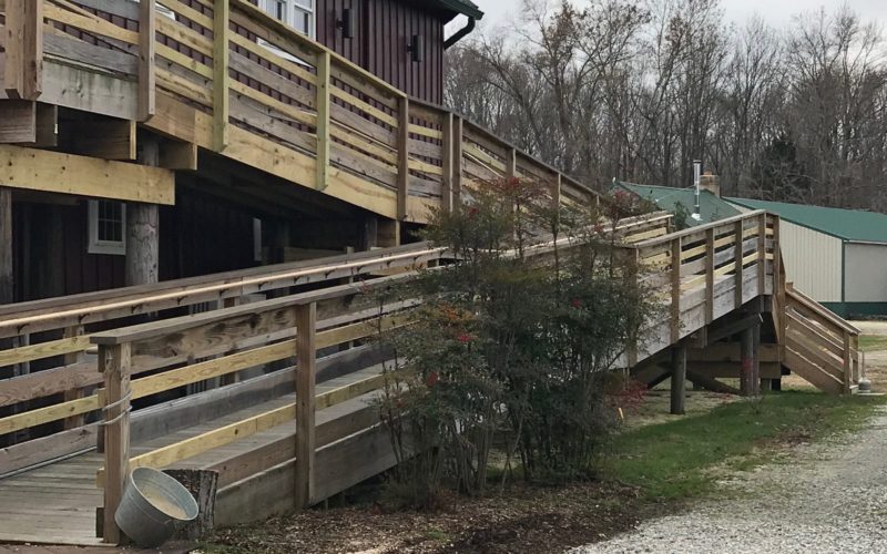 A wooden ramp leading to the side of a building.