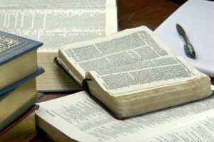 A table with several books and papers on it.