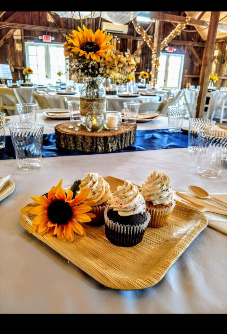 A table with cupcakes and flowers on it