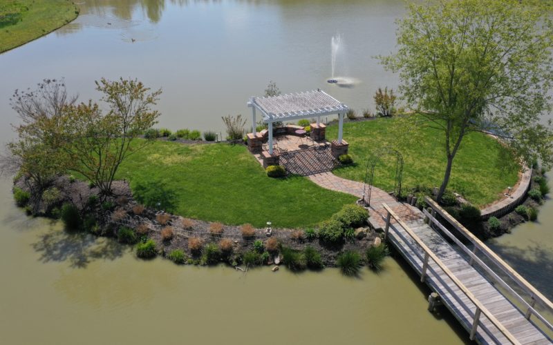 A boat dock with a gazebo and walkway over the water.