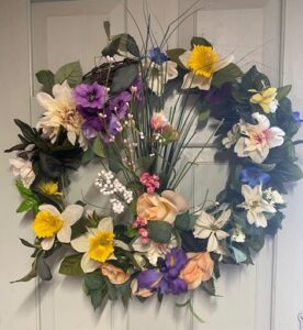 A wreath of flowers is hanging on the door.