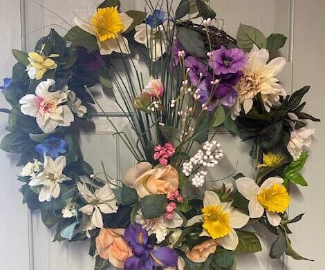 A wreath of flowers is hanging on the door.