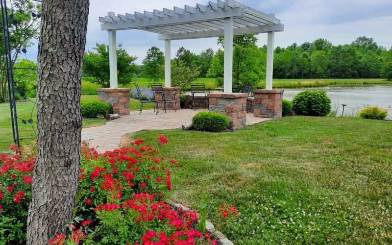 A park with flowers and trees in the background.