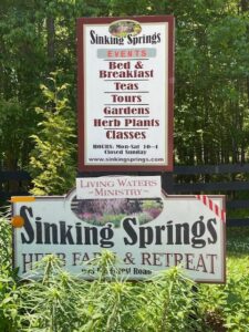 A sign for the sinking springs herb farm and retreat.