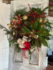 Festive holiday wreath decorated with red, gold, and green accents.